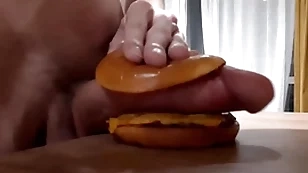 Husky horny teen fucks a burger with a broad in the beam dick increased by cums in it